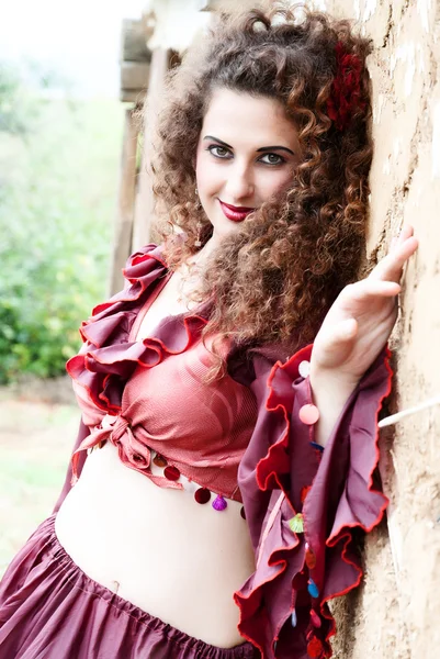 Beautiful gypsy girl in red dress — Stock Photo, Image
