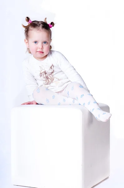 Mal³shka sitting on a chair — Stockfoto