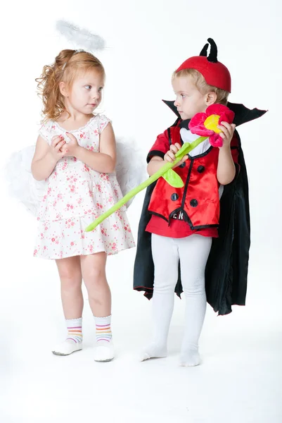 The boy in the image of devil and a girl angel — Stock Photo, Image