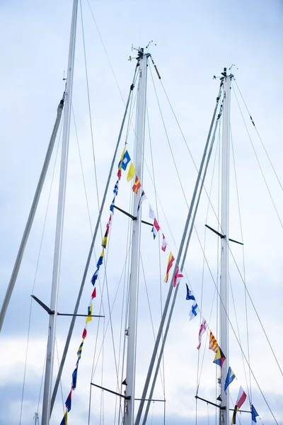 Sail boat masts decorated with flags — Stock Photo, Image