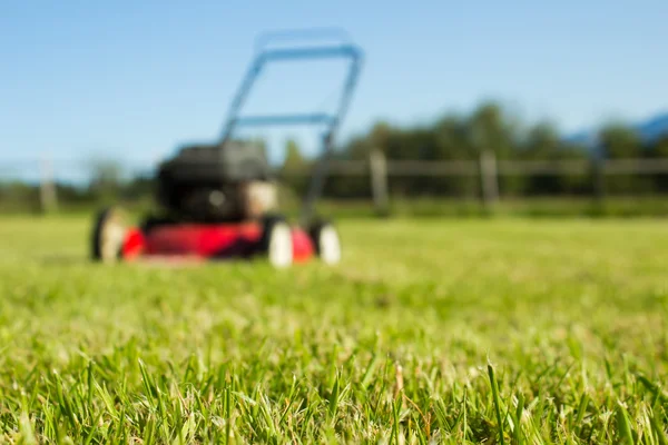 Lawn mower on grass — Stock Photo, Image