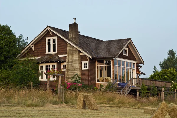 stock image Old Farmhouse with Hay Field