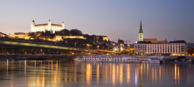 Bratislava - castle and cathedral from riverside in evening clipart