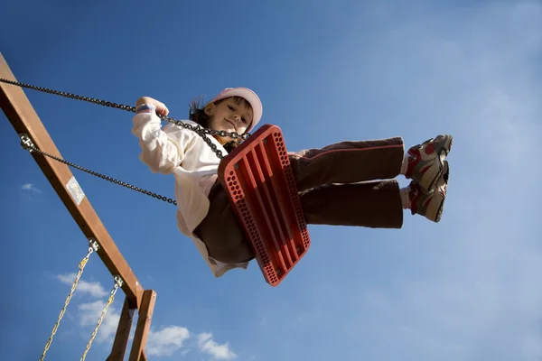 Little girl on the seesaw — Stock Photo, Image
