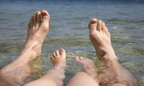 Feet of father and daughter in the see - holiday — Stock Photo, Image