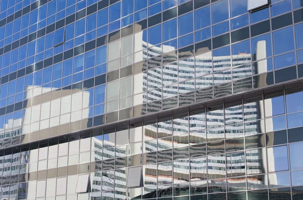 Vienna - mirror of Uno city buildin on the modern glass facade