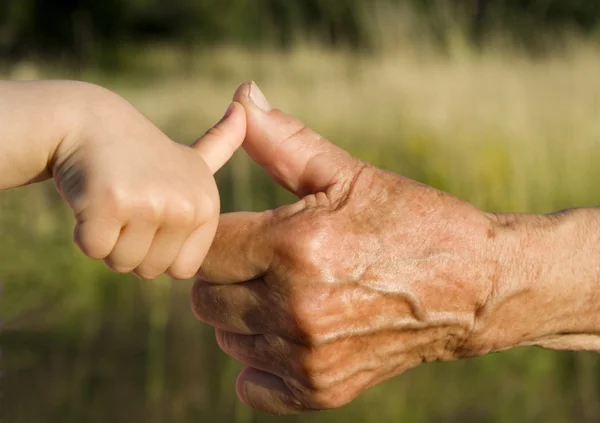 Hands of grandmother and grandchild by play — Stock Photo, Image