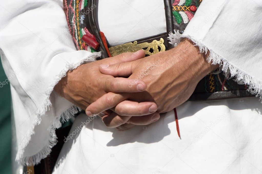 Hands of man in the garb