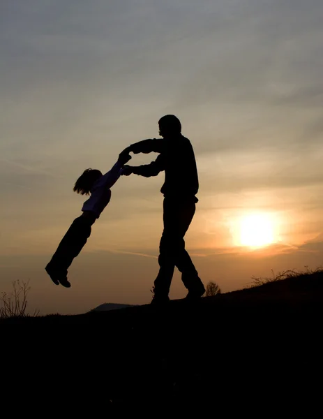 Fun of father and child in sunset - silhouette — Stock Photo, Image