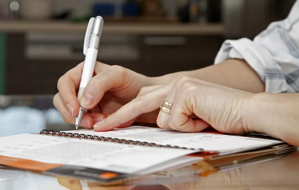 stock image Hands of woman by writing in a calendar