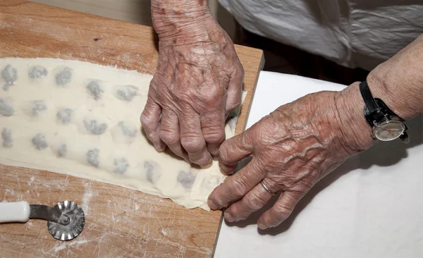 Hands of grandmother at backing — Stock Photo, Image