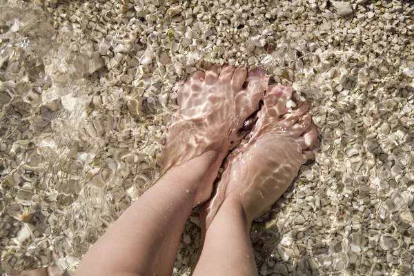 Feet of little girl in the see — Stock Photo, Image