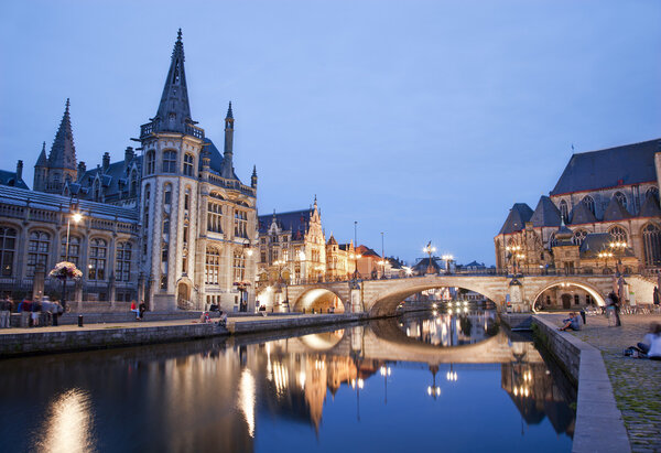 Gent - West facade of Post palace and Michael s bridge with the canal in evening from Graselei street on June 24, 2012 in Gent, Belgium.