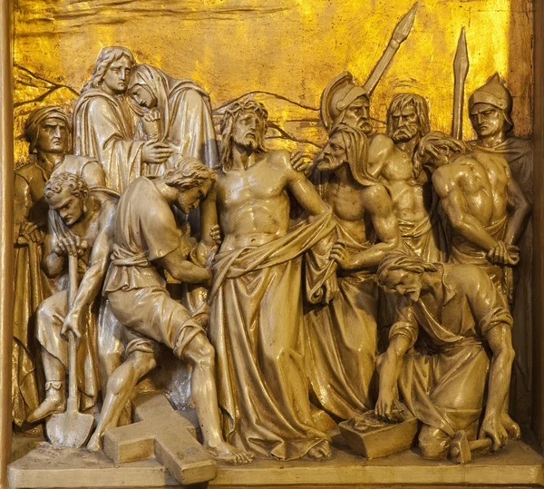 BRUSSELS - JUNE 24: Jesus is stripped of his garments. Relief from Saint Antoine church on June 24, 2012 in Brussels. — Stock Photo, Image