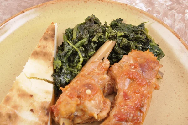 Rabbit cacciatore with spinach — Stock Photo, Image