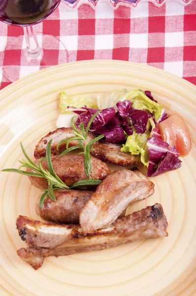 Pork chops with fried sausages — Stock Photo, Image