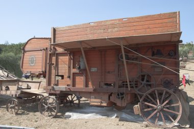 Ancient machine for threshing wheat 60 years clipart