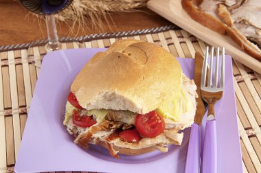 Porchetta sandwich with lettuce and tomatoes clipart