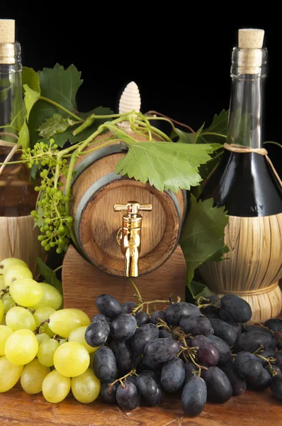 stock image In oak casks with vines and grapes white and black