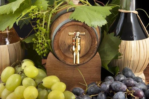 stock image In oak casks with vines and grapes white and black