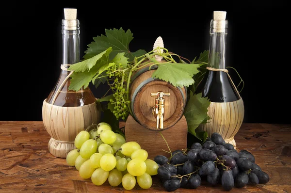 stock image In oak casks with vines and grapes white and black