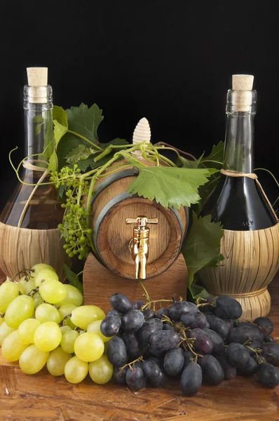 stock image In oak casks with vines and grapes white and black