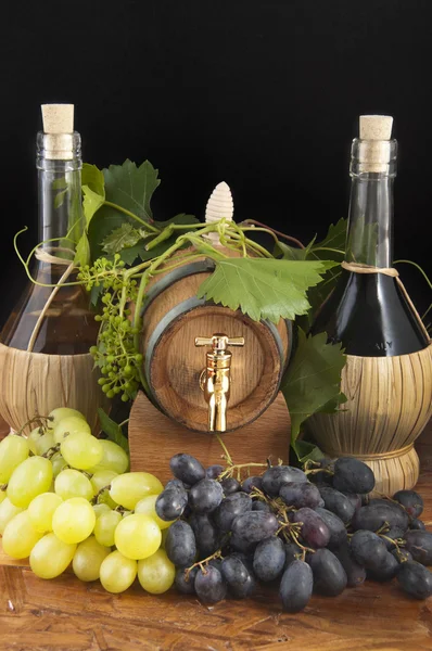 stock image In oak casks with vines and grapes white and black