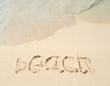 Beah title drawing on the sand beach near the ocean clipart