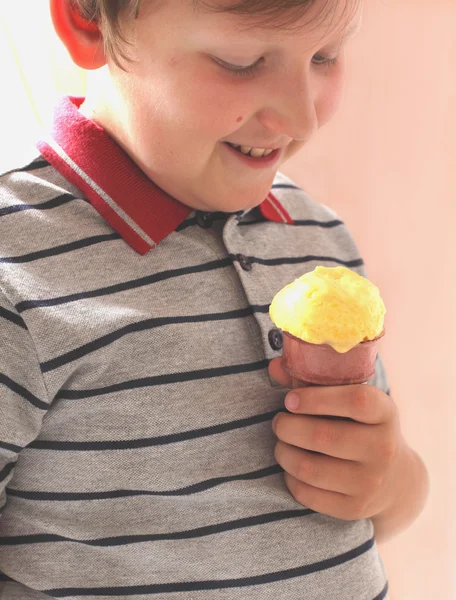 Stock image The boy is eating mango ice cream