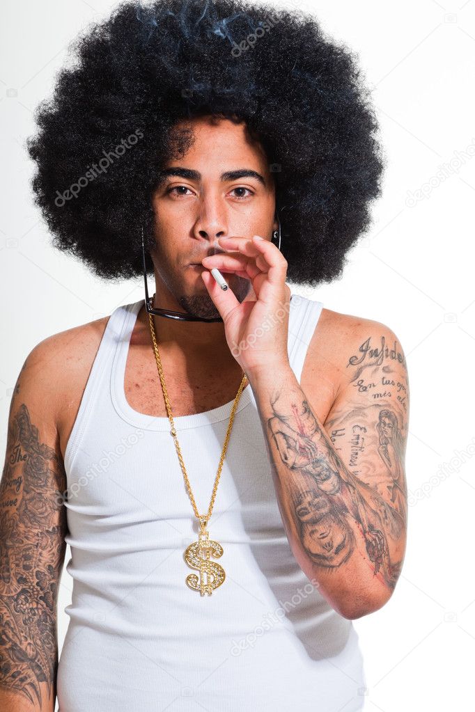 Hip hop urban black man retro afro hair wearing white shirt and bling bling isolated on white. Smoking cigarette. Looking confident. Cool guy. Studio shot.
