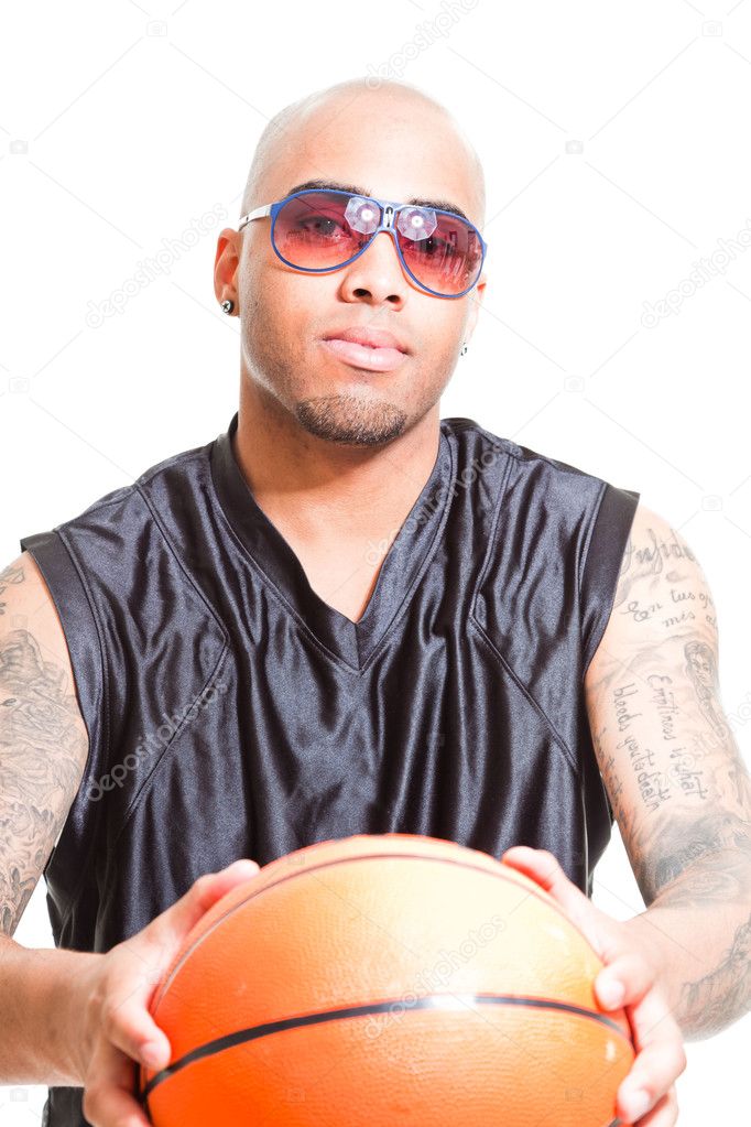 Studio portrait of basketball player wearing black sunglasses standing and holding ball isolated