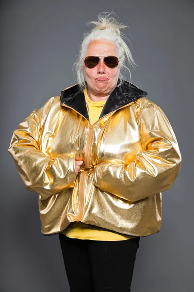 Cool magas rangú nő visel arany kabát. hosszú, szürke haj. napszemüveg. stúdió felvétel. elszigetelt. — Stock Fotó