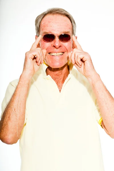 Expressive good looking senior man casual summer dressed against white wall. Wearing sunglasses. Happy, funny and characteristic. Isolated. Studio shot. — Stock Photo, Image