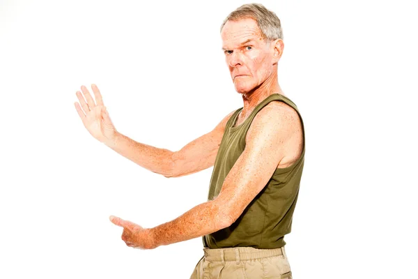 Athletic good looking senior man casual summer dressed against white wall. Working out his muscles. Happy, funny and characteristic. Isolated. Studio shot. — Stock Photo, Image