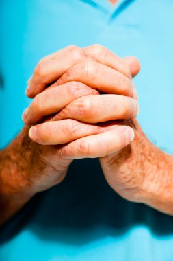 Spiritual hands of senior man. Closeup. Studio shot. clipart