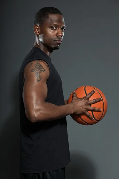 Giocatore di basket nero americano. Studio ritratto isolato su sfondo grigio . — Foto Stock