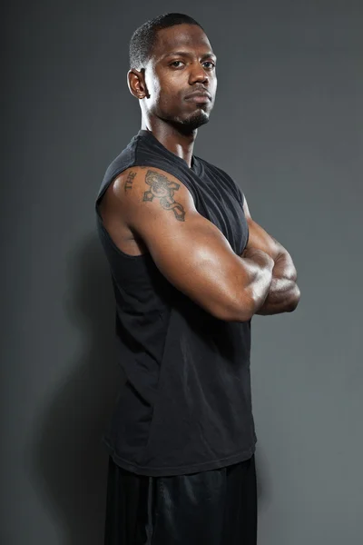 Černý americký basketbalista. Studiový portrét izolovaných na šedém pozadí. — Stock fotografie