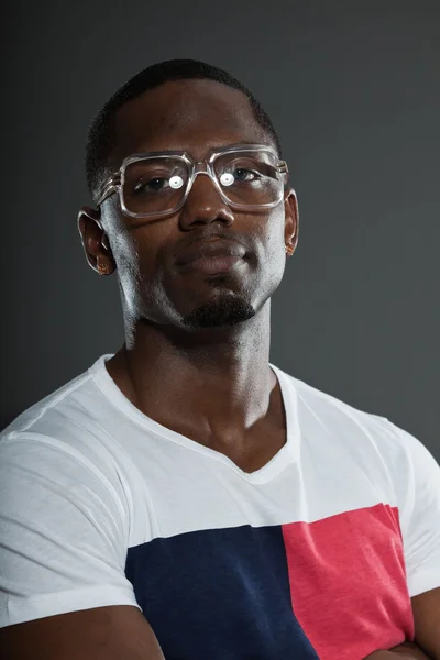 Cool urban stylish black american man. Fashion studio portrait isolated on grey background. Wearing retro glasses. — Stock Photo, Image