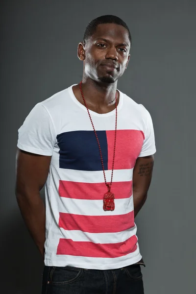 Cool urban stylish black american man. Fashion studio portrait isolated on grey background. — Stock Photo, Image