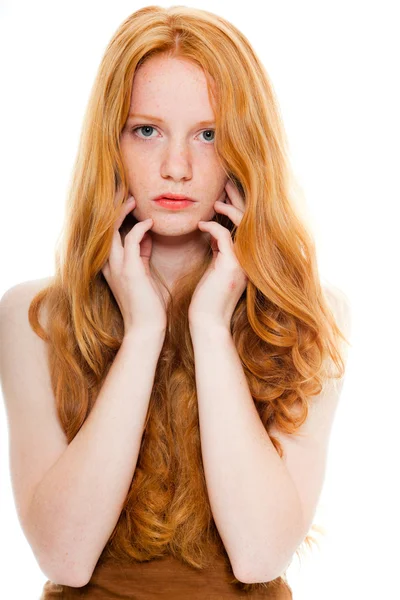 Pretty girl with long red hair wearing brown shirt. Fashion studio shot isolated on white background. — Stock Photo, Image