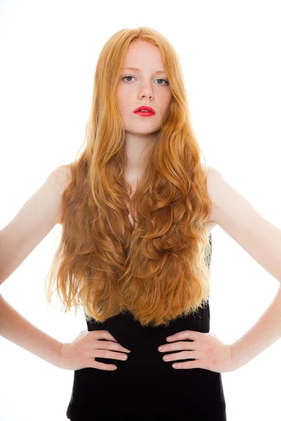 Pretty girl with long red hair and lipstick wearing black shirt. Fashion studio shot isolated on white background. — Stock Photo, Image