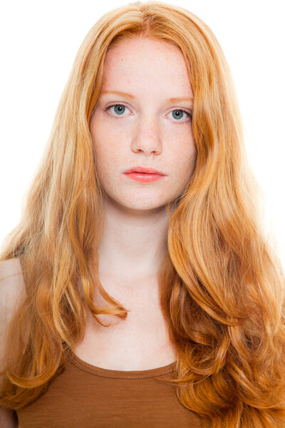 Pretty girl with long red hair wearing brown shirt. Fashion studio shot isolated on white background.