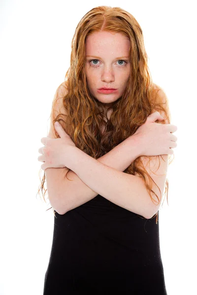 Pretty girl with long red hair wearing black shirt. Wet hair and face looking sad. Fashion studio shot isolated on white background. — Stock Photo, Image