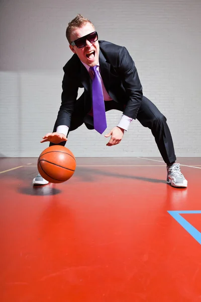 Business man with basketball. Wearing dark sunglasses. Good looking young man with short blond hair. Gym indoor. — Stock Photo, Image