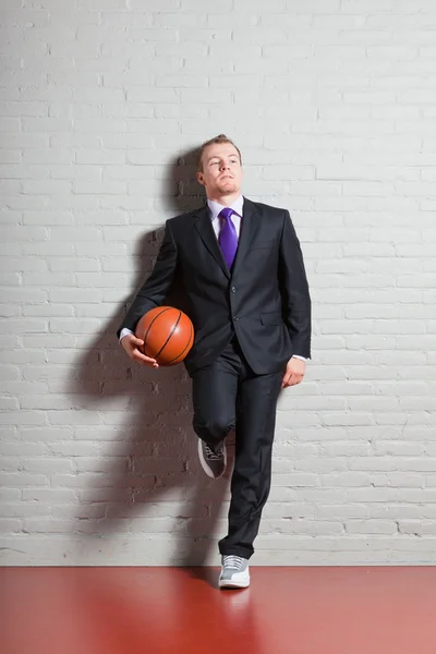 stock image Business man with basketball. Good looking young man with short blond hair. Gym indoor.