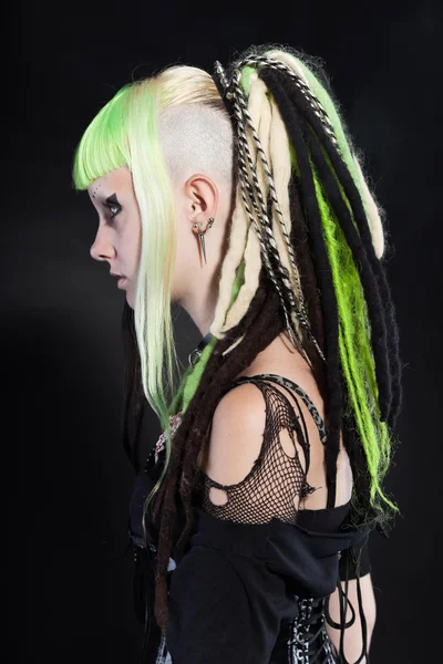 Cyber punk girl with green blond hair and red eyes isolated on black background. Expressive face. Studio shot. — Stock Photo, Image