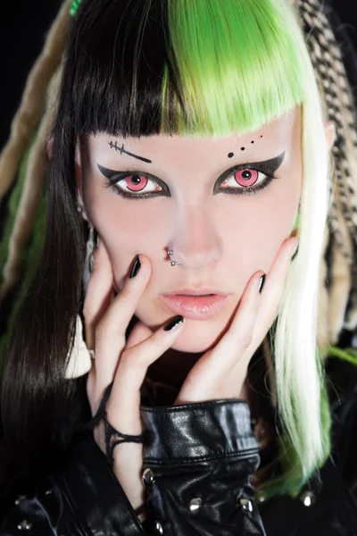 Cyber punk girl with green blond hair and red eyes isolated on black background. Expressive face. Studio shot. — Stock Photo, Image