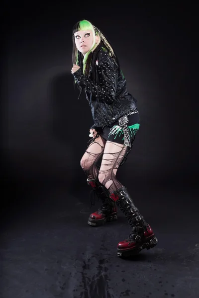 Cyber punk girl with green blond hair and red eyes isolated on black background. Expressive face. Scared looking. Studio shot. — Stock Photo, Image