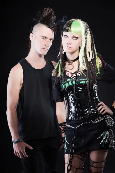 Couple of cyber punk girl with green blond hair and punk man with mohawk haircut. Isolated on black background. Studio shot. — Stockfoto
