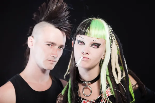 Couple of cyber punk girl with green blond hair and punk man with mohawk haircut. Isolated on black background. Studio shot. — Stockfoto
